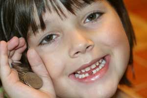 girl with missing tooth and money